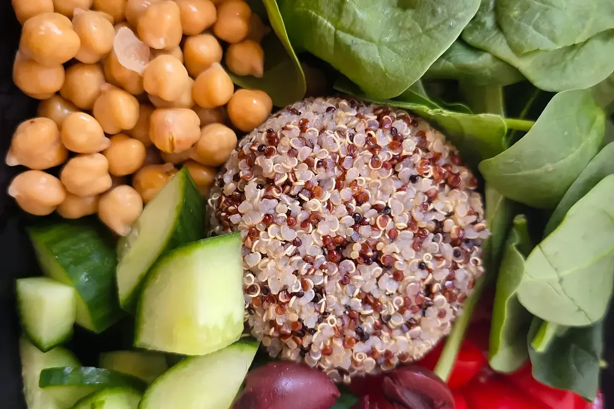 lunch bowl with chickpeas, quinoa, cucumber, and greens